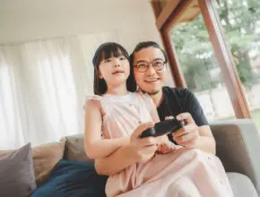 father and daughter playing video game
